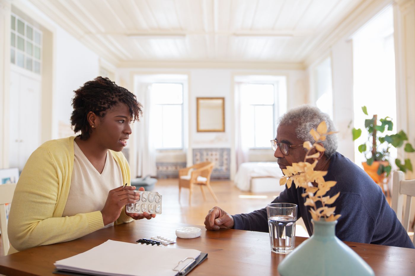 Site coordinator reviewing study medications with a participant